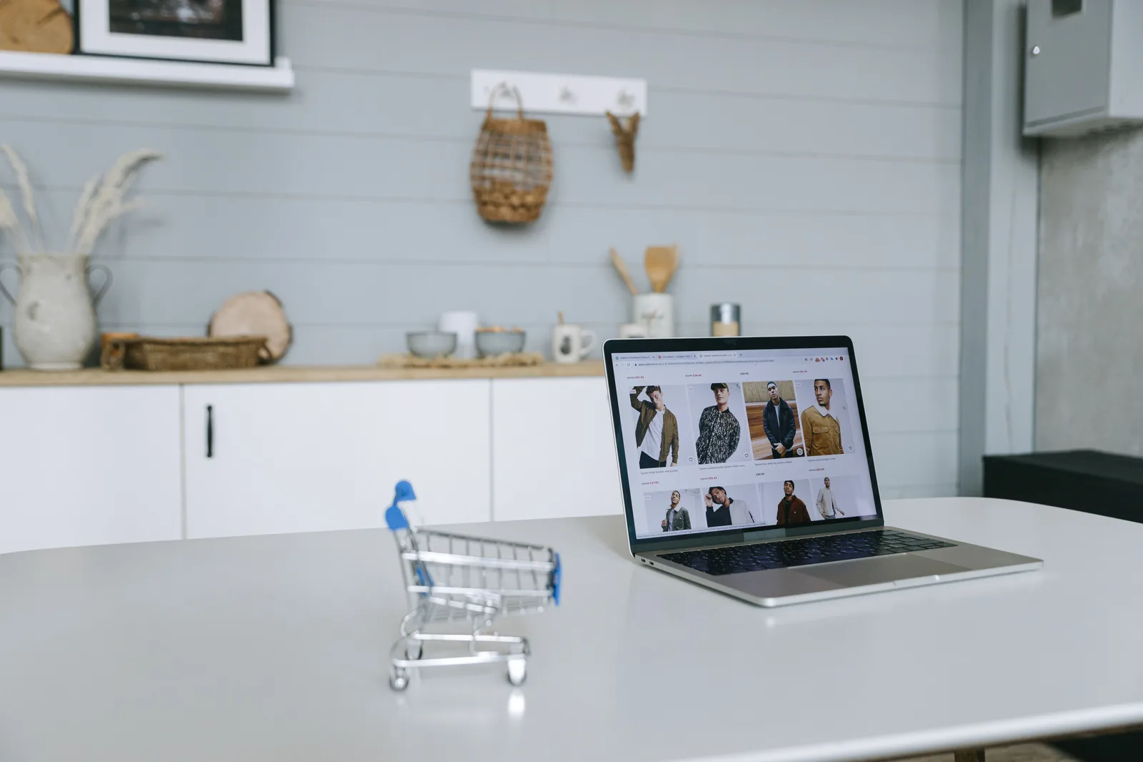 Laptop on a clean desk showing an e-commerce website dashboard in a bright modern office workspace
